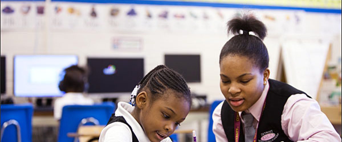 Tamira Mitchell, right, a 16 year old 10th grader helps Winter Smith, a 6 year old kindergartner with her writing assignment at Detroit International Academy for Young Women on Wednesday morning, January 11, 2012.